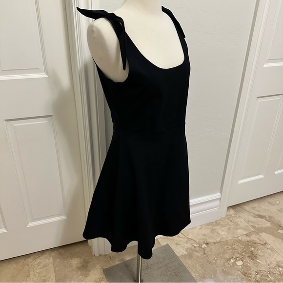 Fun short black knit flirty bow strap day dress. - Picture 3 of 6